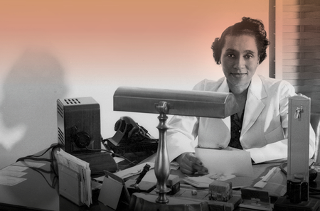 Helen O. Dickens, MD, wearing a white coat and seated at a desk in 1947